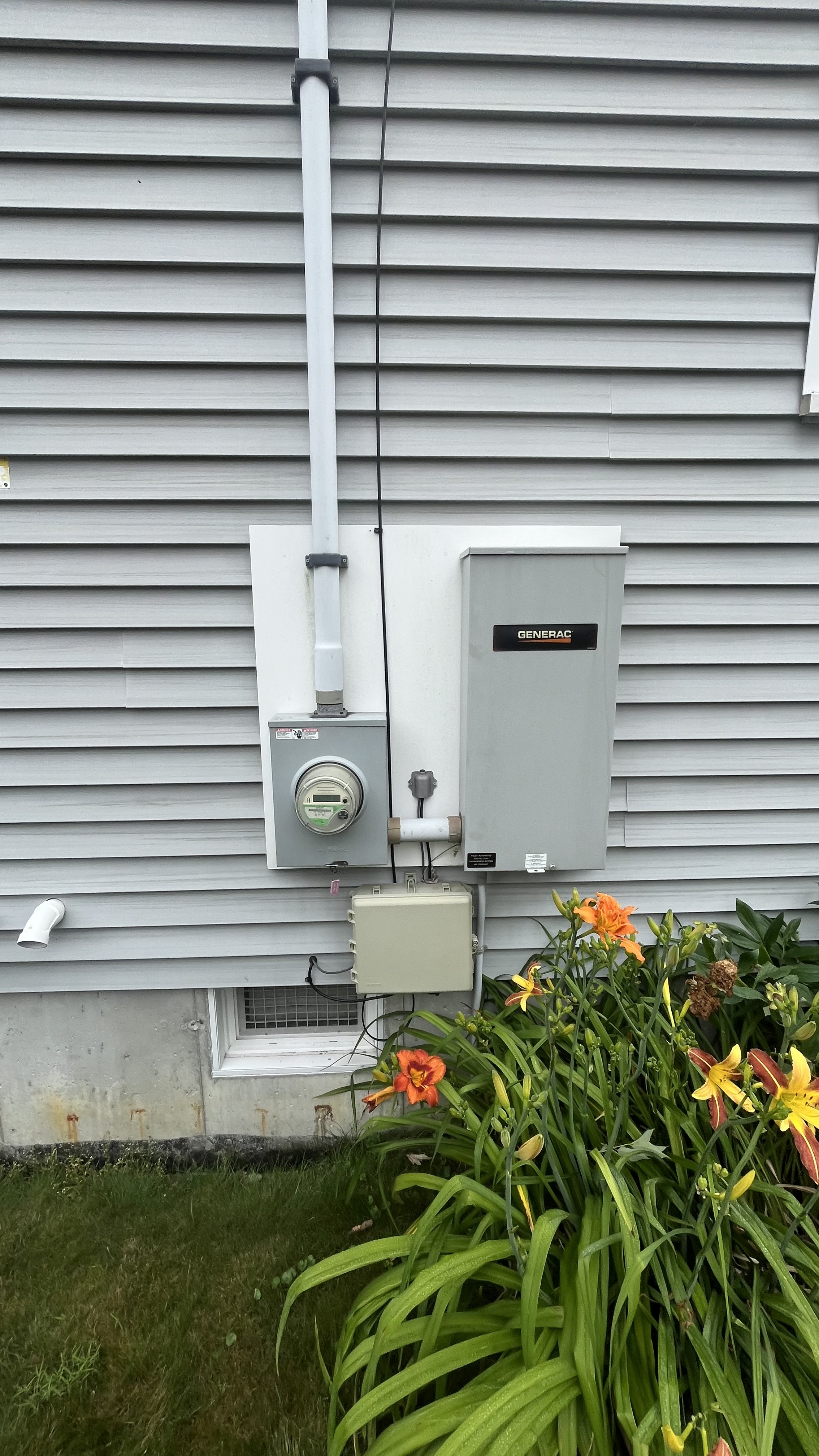A water heater sitting on the side of a building